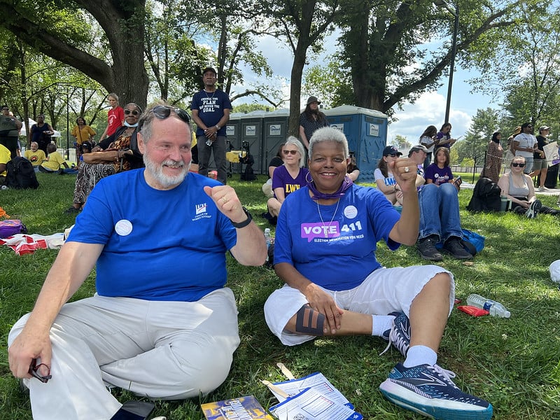 Dr. Turner and her husband at a rally smiling and raising their fists in solidarity