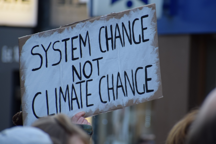 A sign that says "System Change, Not Climate Change"