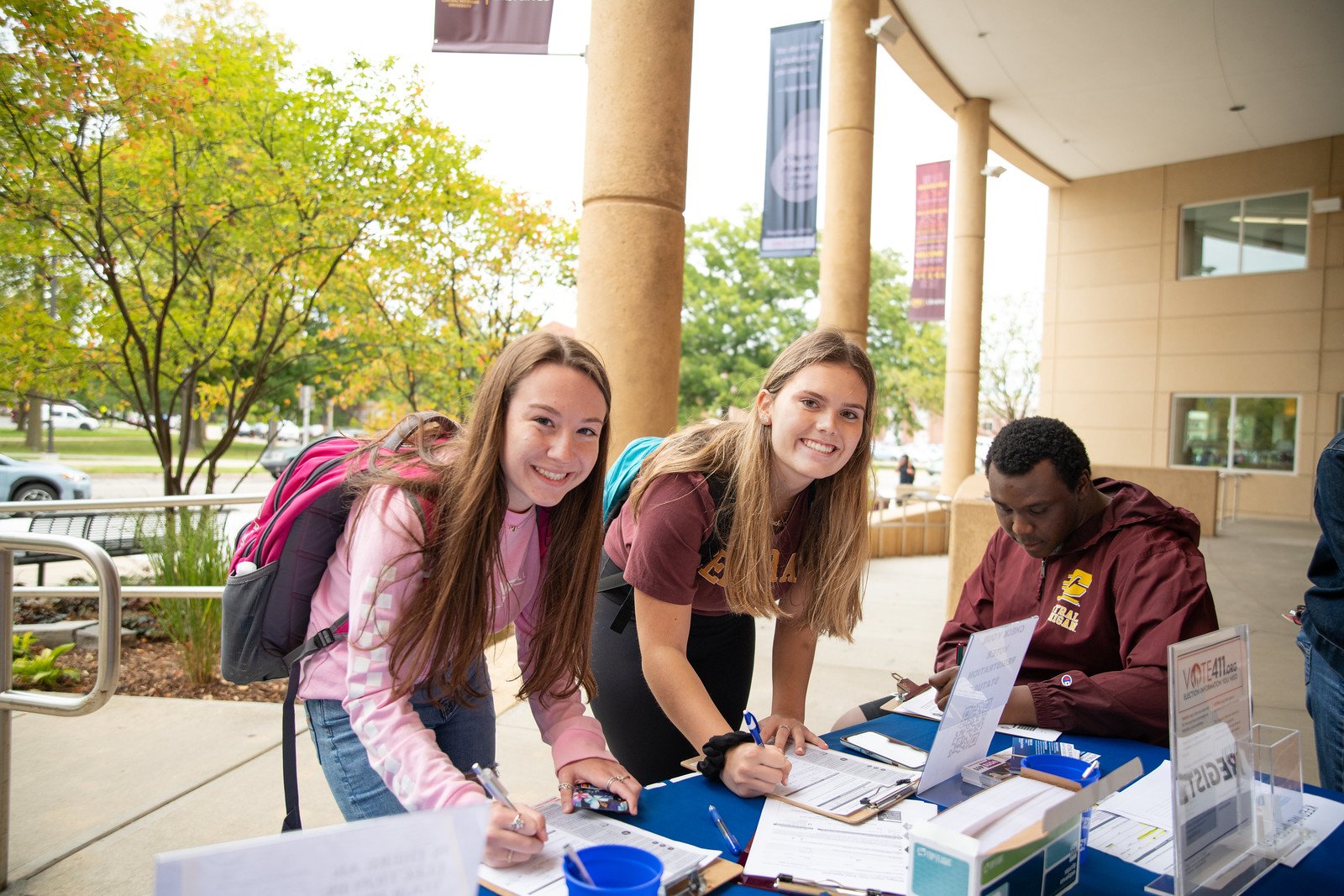 Two girls and a man registering to vote