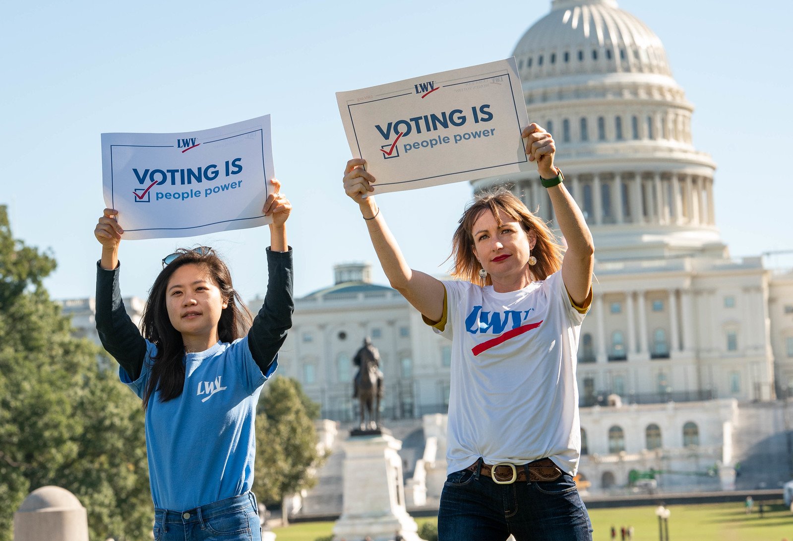 Women holding voting rights signs outside the US Capitol