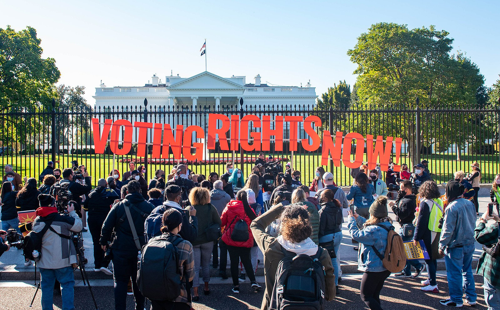 Signs that say "Voting Rights Now" in front of the White House