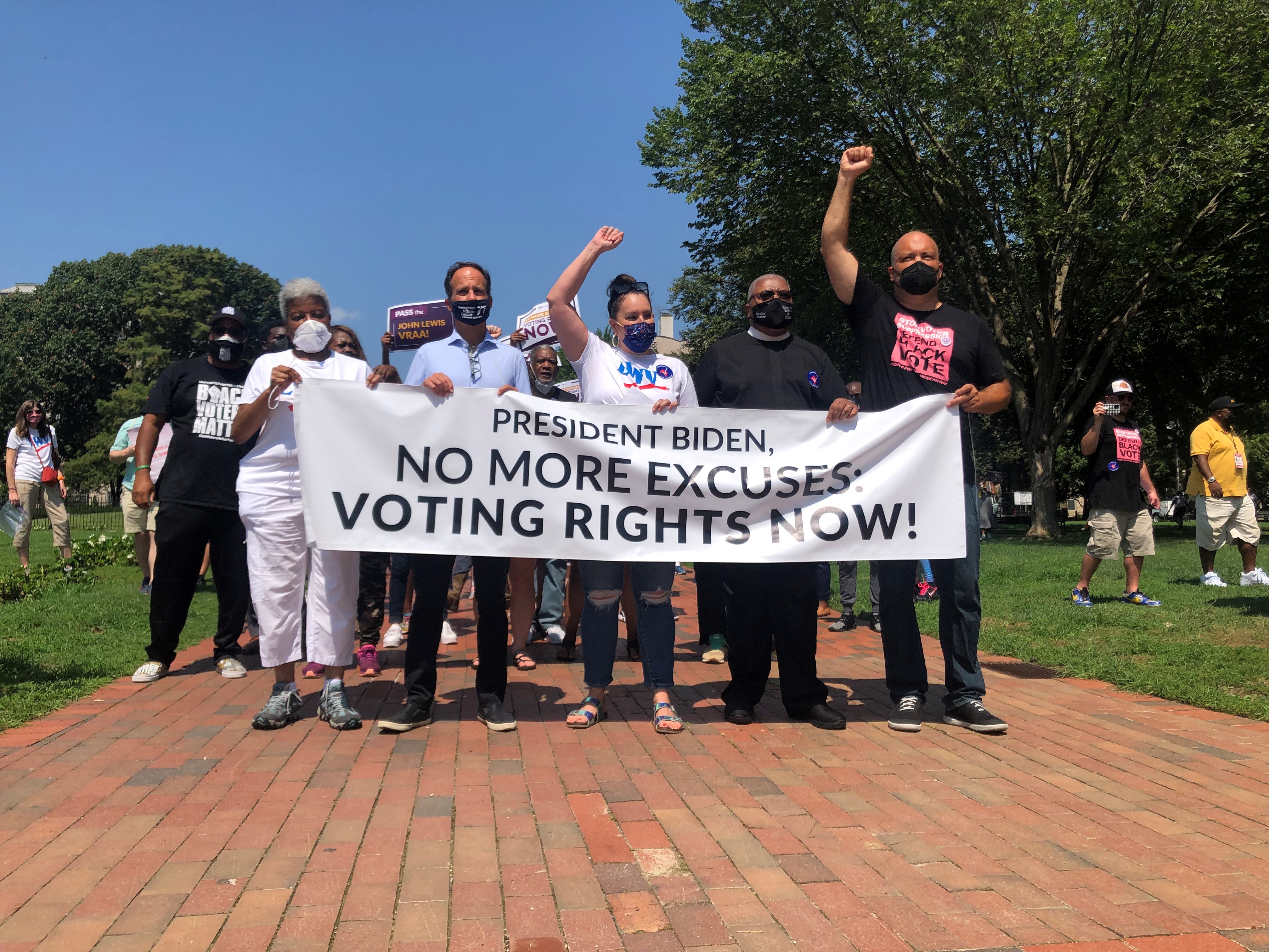 Photo of Dr. Deborah Ann Turner, Rabbi Pesner, Virginia Kase Solomón, Rev. McDonald, and Ben Jealous holding a banner that reads "President Biden, No more excuses: Voting Rights Now!"