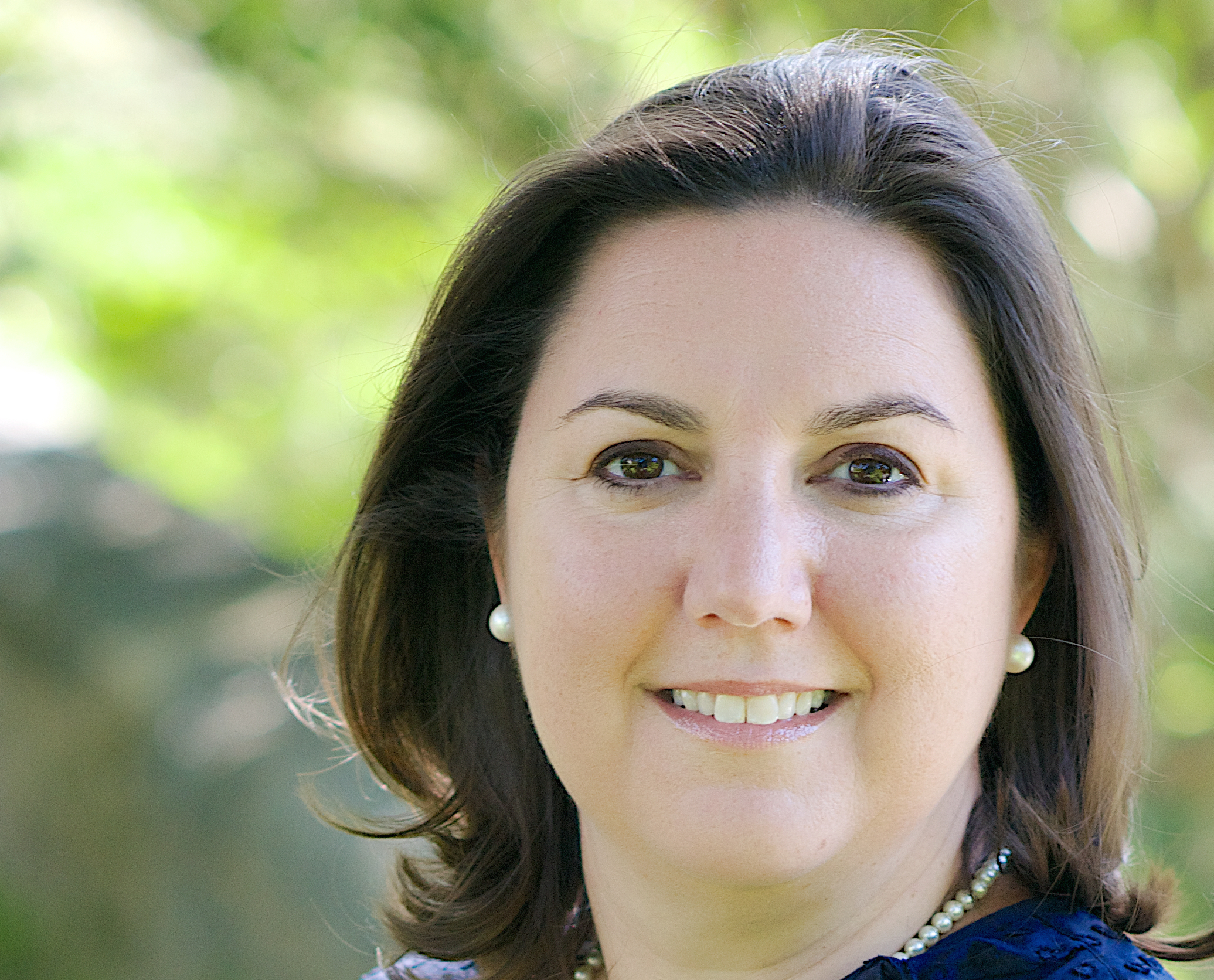 Image of Cecilia Calvo, a woman with short brown hair, looking at the camera
