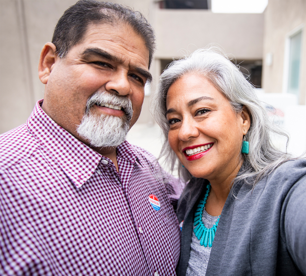 Two people smiling at the camera