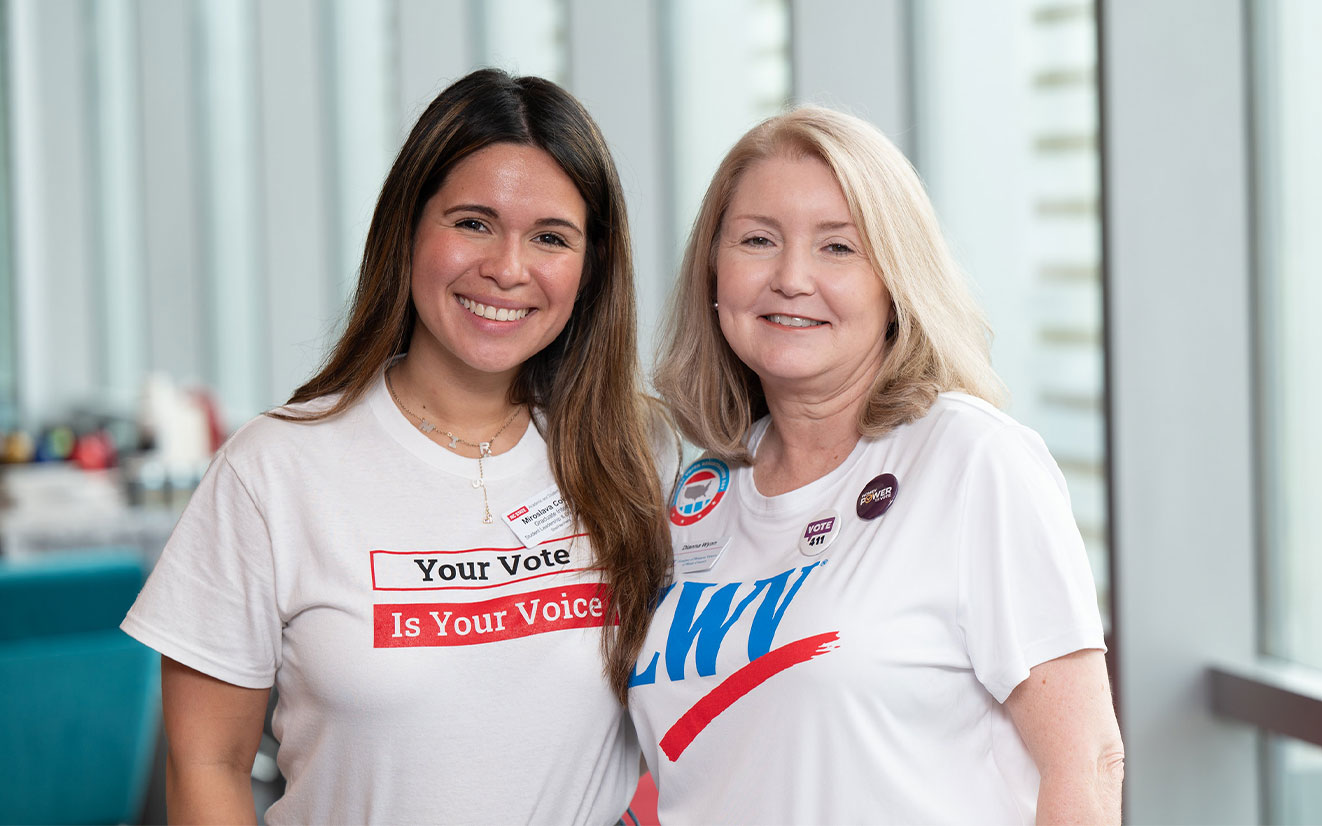 LWV President Dianna Wynn and another woman smiling and wearing pro-voting T-shirts
