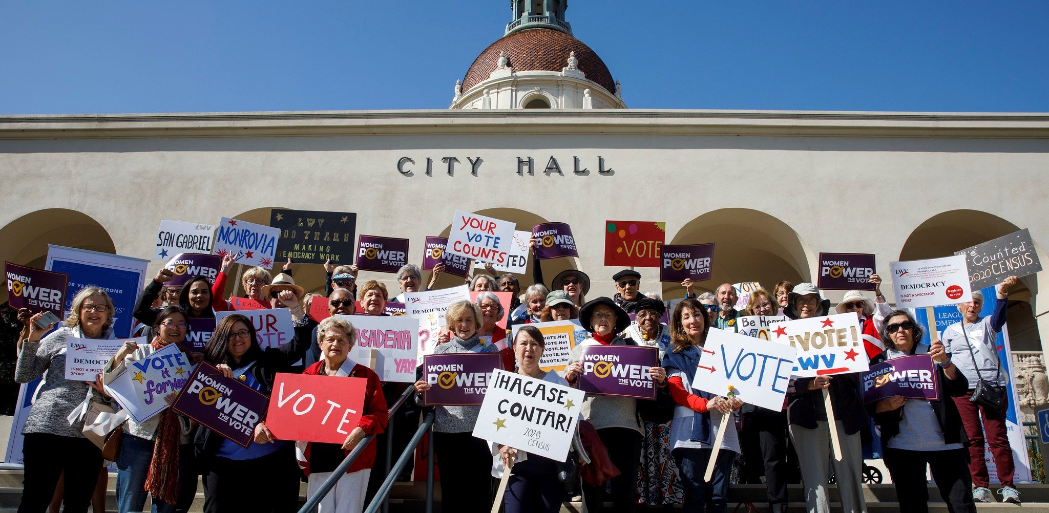 Large group of LWV members with signs that get out the vote in front of Pasadena City Hall