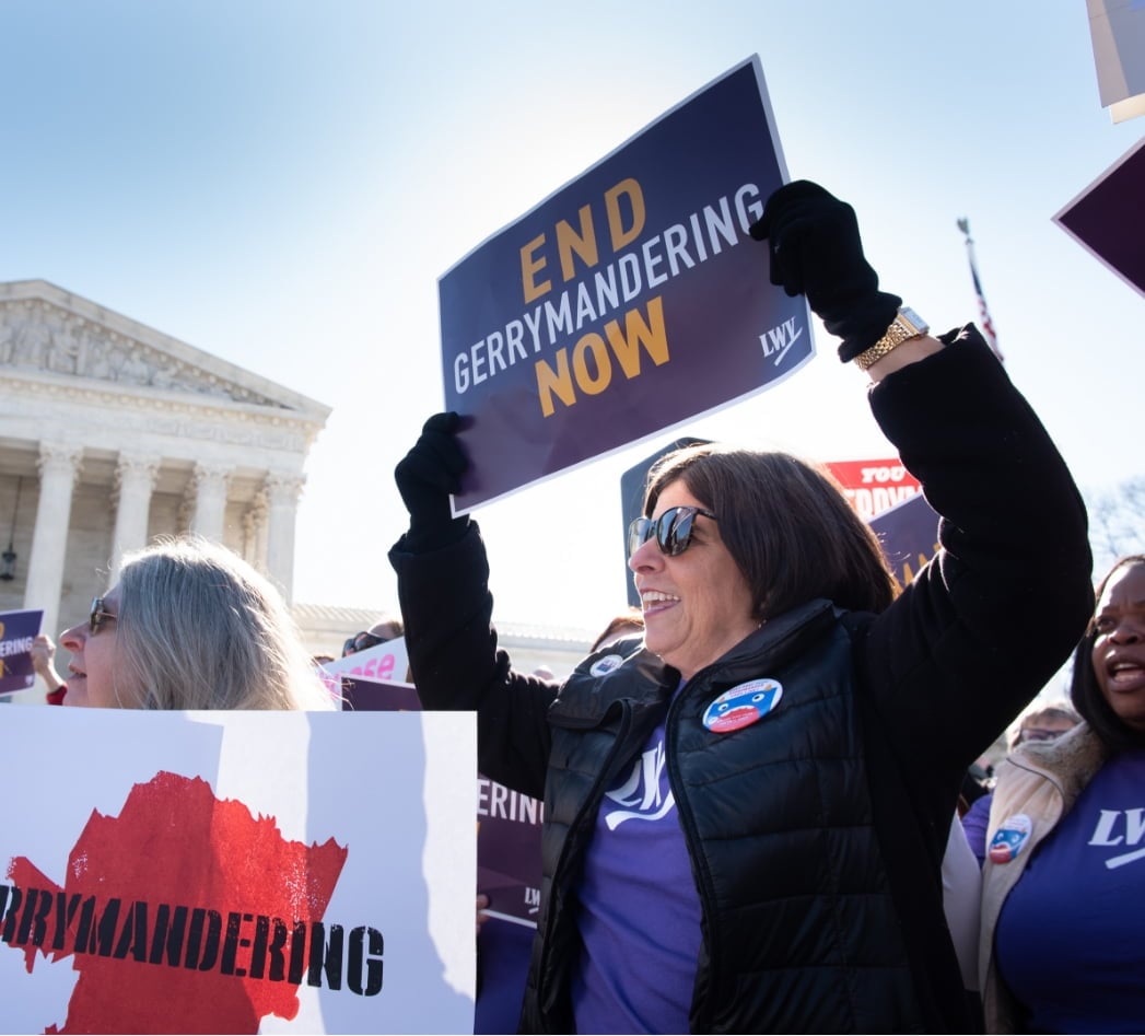 Woman holding protest sign to End Gerrymandering Now