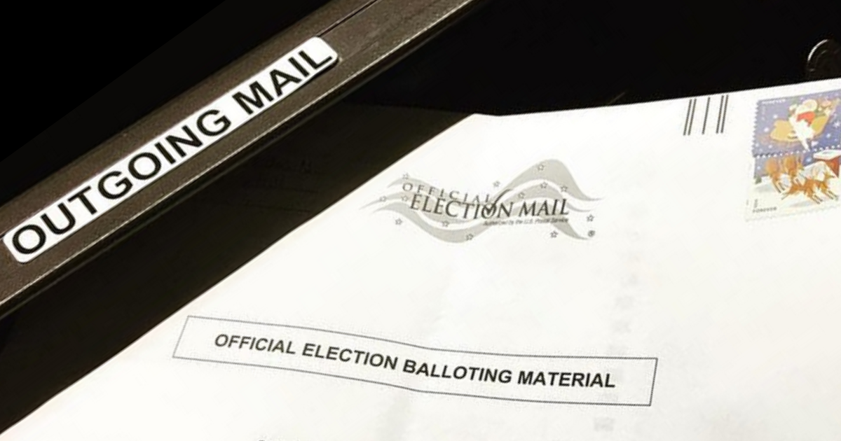 Mail ballot being inserted in mail slot