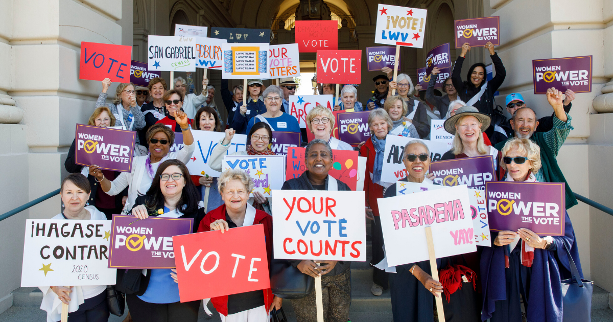 Group holding voting signs