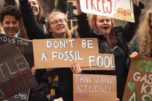 Protestor holding a sign that says "don't be a fossil fool"