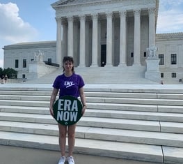A League member holding an ERA sign in front of the US Capitol