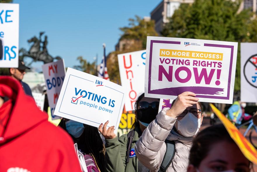 Signs that say "Voting Rights Now"