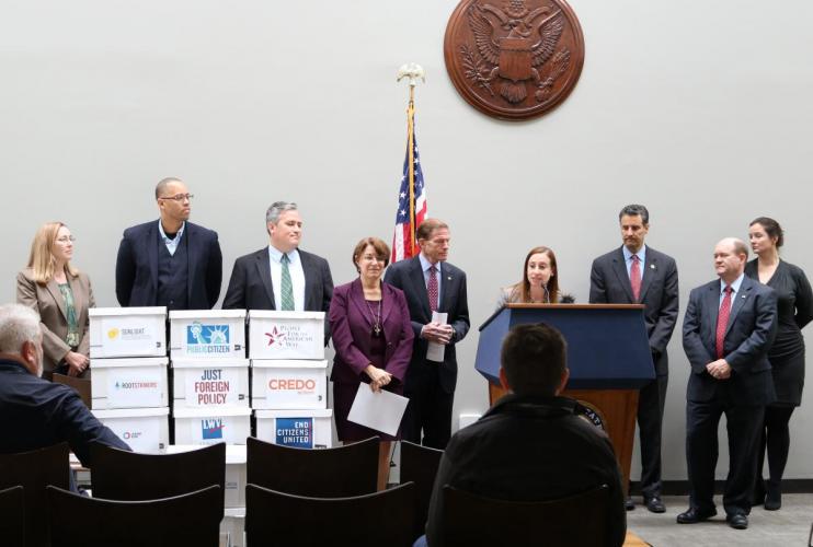 Jeanette Senecal, Senior Director of Elections, stands with  at a press conference urging the Federal Election Commission (FEC) to require online political advertisements to disclose their sources of funding.