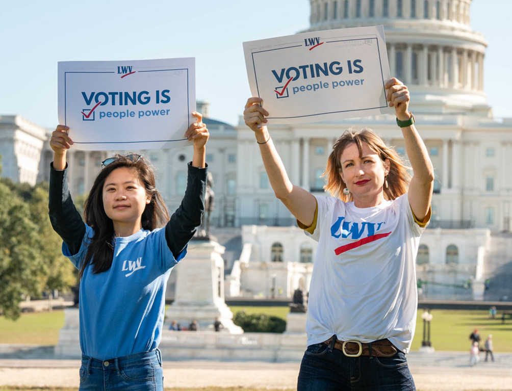 Members at Capitol holding voting rights signs