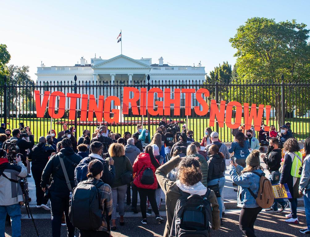 Signs that say "Voting Rights Now" in front of the White House