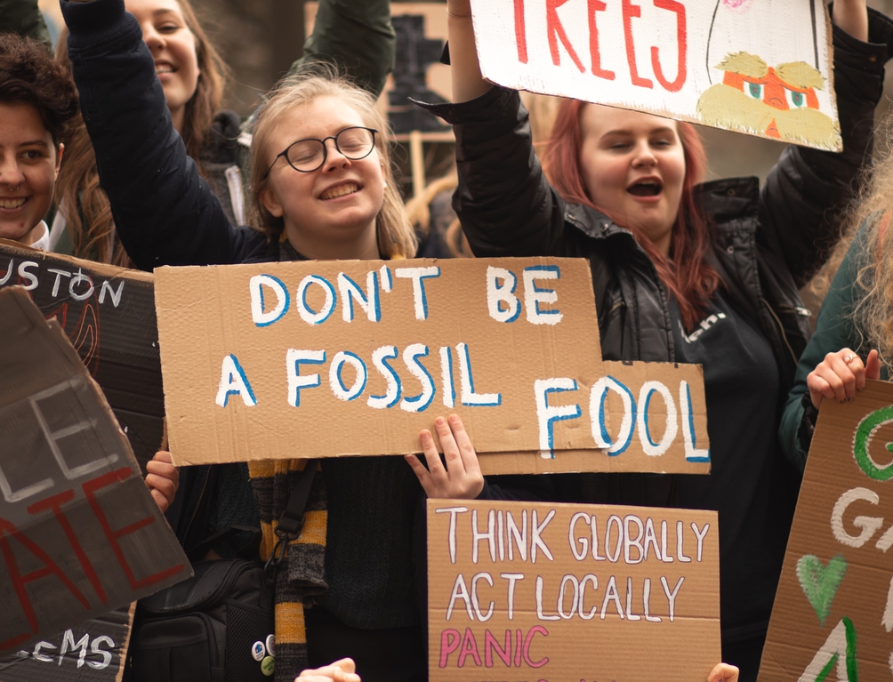 Protestor holding a sign that says "don't be a fossil fool"