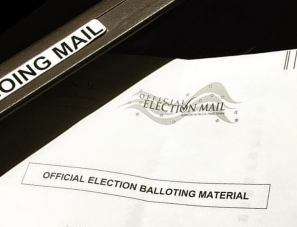 Mail ballot being inserted in mail slot