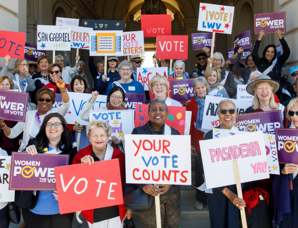 Group holding voting signs