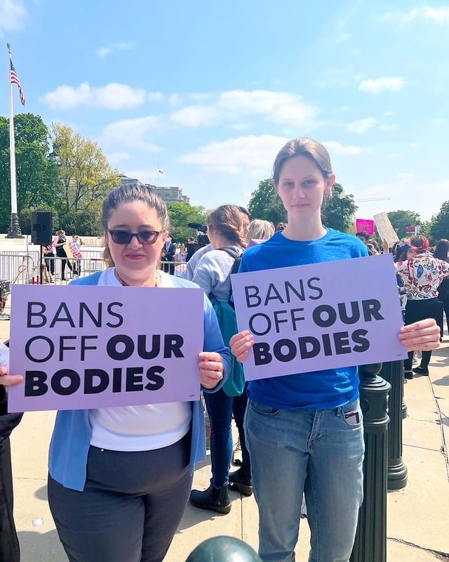 LWV staff at a reproductive rights rally holding "Bans Off Our Bodies" signs