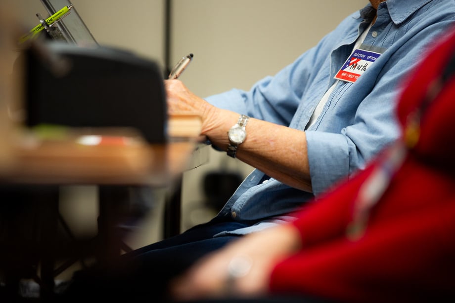 A person filling out their ballot