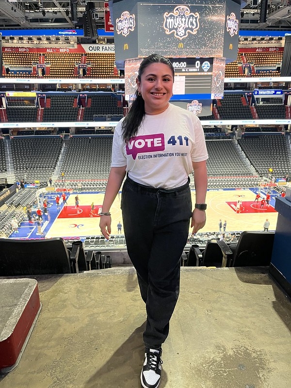 A women in a VOTE411 shirt at the Mystics stadium