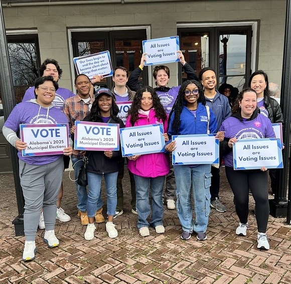 Activists holding signs promoting the freedom to vote at Selma in 2025