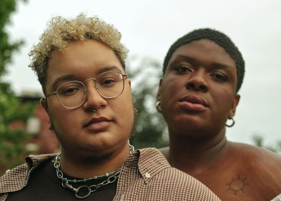 Two LGBQIA people looking straight at the camera