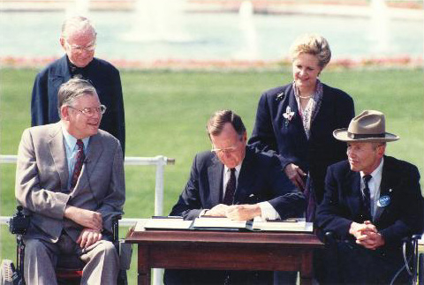 Former President George Bush signs the Americans with Disabilities Act