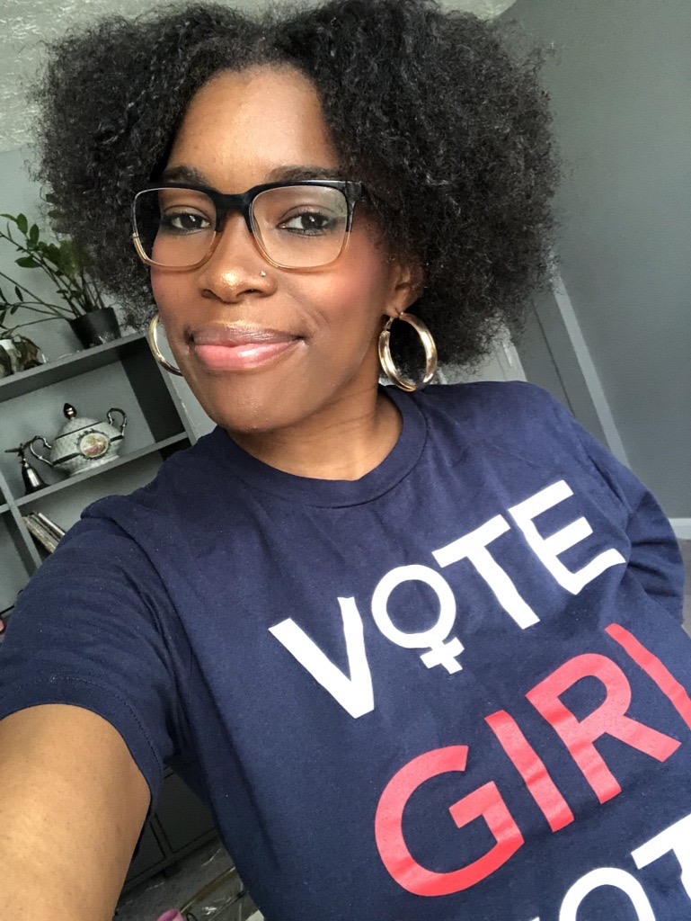Marketing Manager LaQuita Howard wearing a shirt that says "Vote Girl"