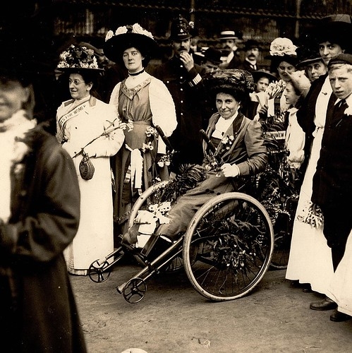 Rosa May Billinghurst marching in her tricycle with suffragists