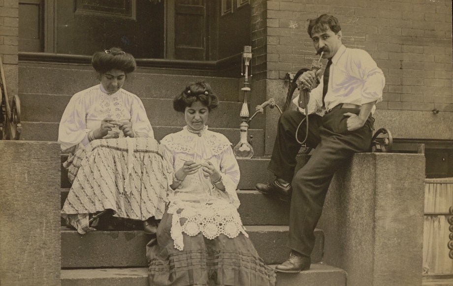 Syrian immigrants doing lacework on a stoop in 1909