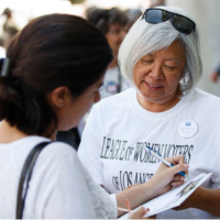 League member registering a woman to vote