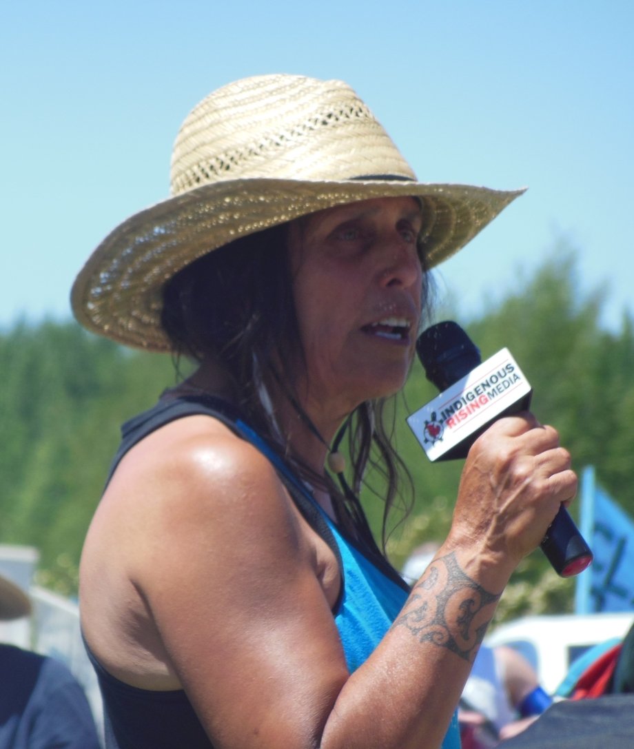 Winona LaDuke speaking into a microphone at a rally