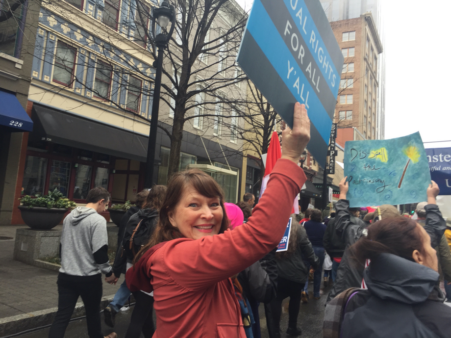 Sherry Macqueen standing at a rally with an equal rights sign