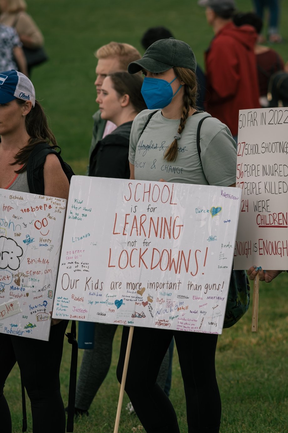 Gun control protestor holding a sign that says "School is for learning, not lockdowns"