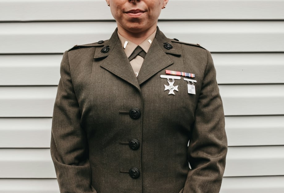 The lower face and torso of a person in military uniform