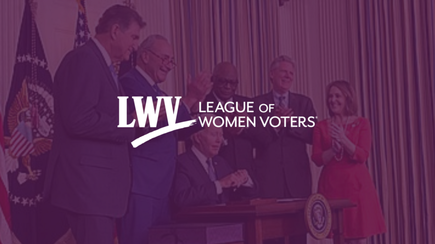 Image of Biden signing the Inflation Reduction Act surrounding by colleagues with a purple overlap and the LWV logo in the center