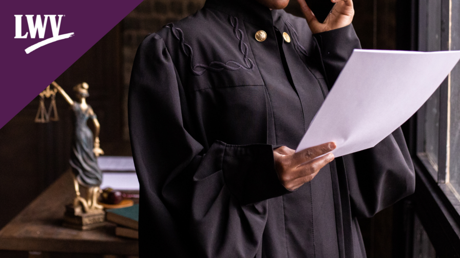 A Black, female judge reading a document