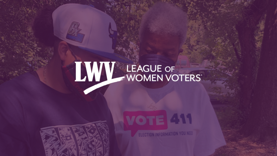 An LWV member and President Dr. Deborah Ann Turner registering to vote