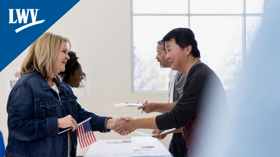 An election worker helping someone vote