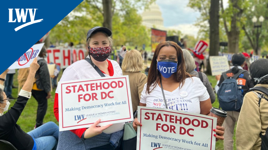Two people holding DC Statehood signs