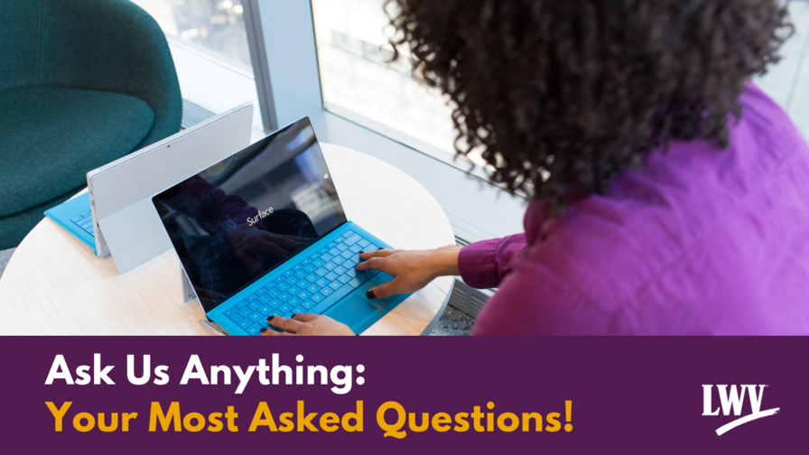 Woman in purple shirt typing on a laptop