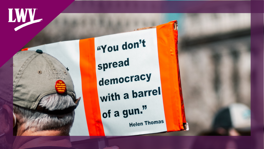Sign saying "you don't spread democracy with the barrel of a gun"