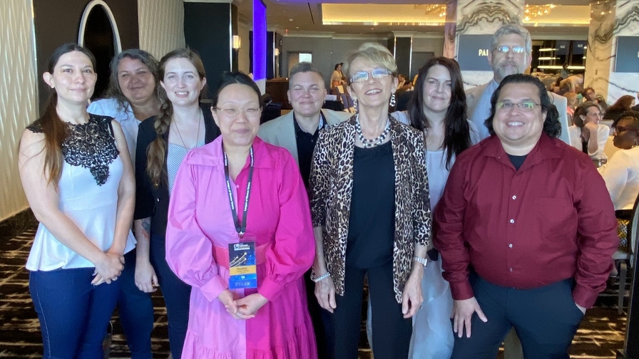 Board members of the League of Women Voters of Nevada stand together, smiling indoors