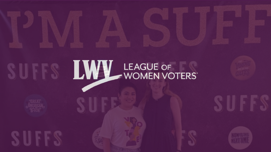 League members in front of a Suffs step-and-repeat with a purple overlay and the LWV logo centered