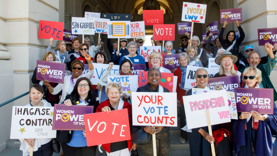 Group holding voting signs