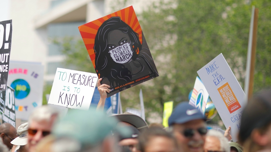 Protesters holding signs about climate change