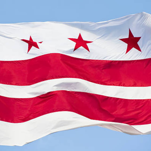 DC Flag flying against blue sky